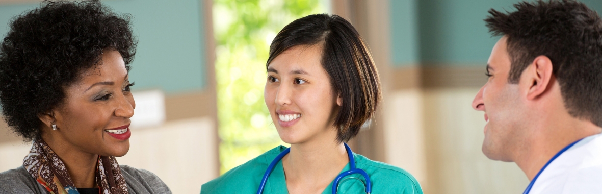 Photo of patient speaking with doctor and nurse