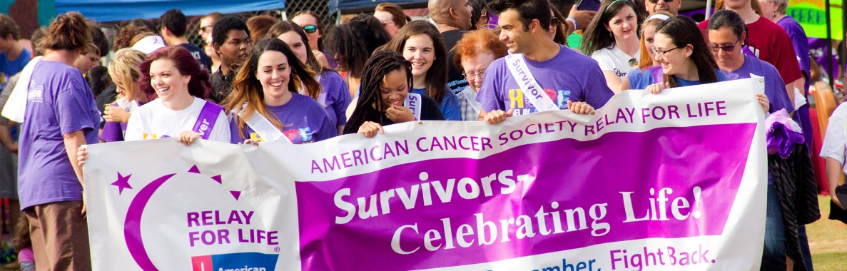 Photo of Relay for Life event participants marching Photo of Relay for Life event participants marching