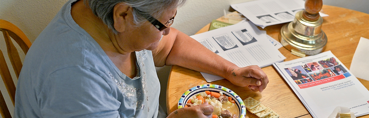 Photo of a woman eating a bowl of soup