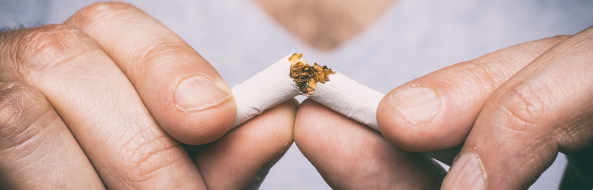 Photo of a woman breaking a cigarette in half