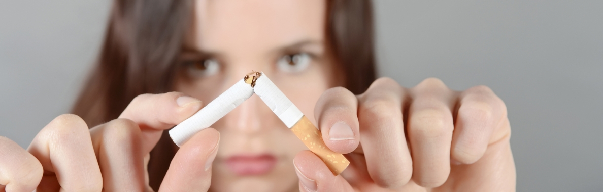 Photo of a woman breaking a cigarette in half