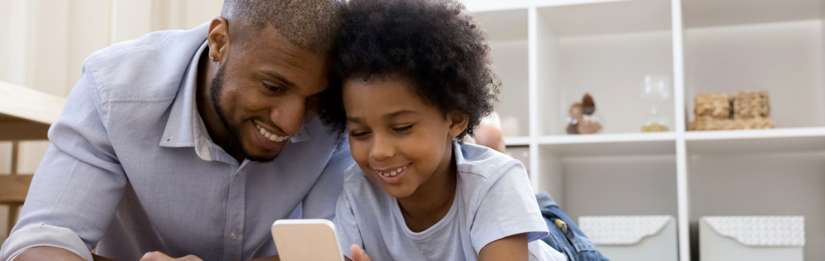 Father and son looking at a phone