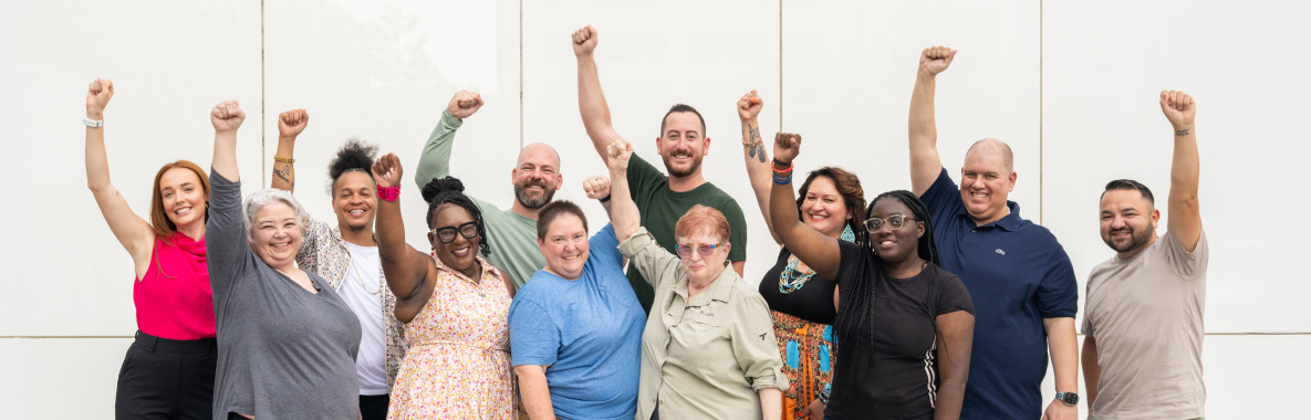 Volunteers with arms raised
