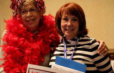 Women holding a folder at an event