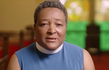 Video still female priest being interviewed